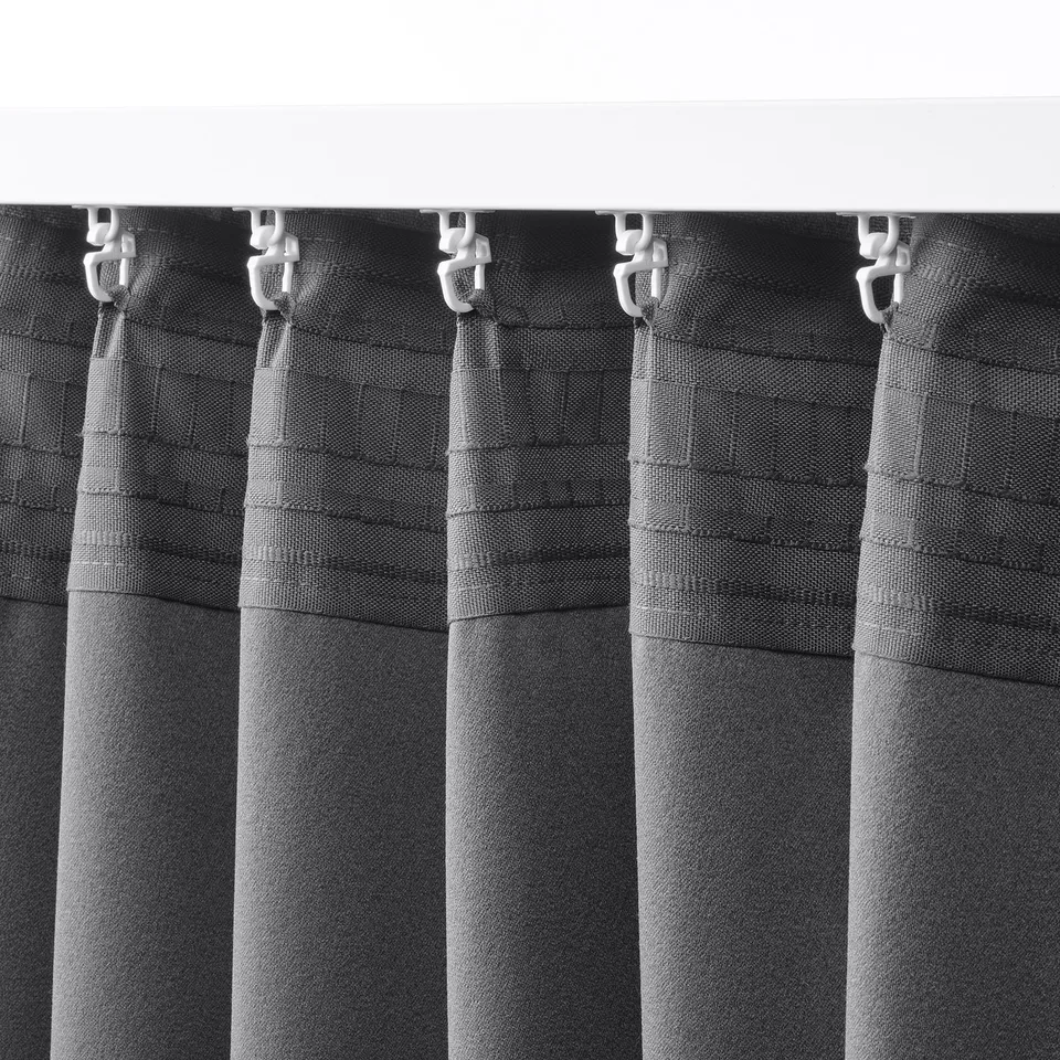 Black and white hanging curtains with clips. Curtains have dark grey pattern and are designed for room darkening and privacy.