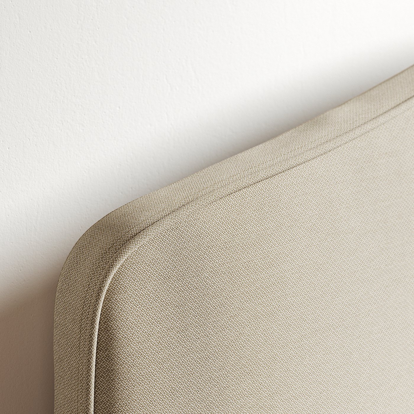 Close-up of ramnefjall bed, smooth beige fabric, neat stitching, soft texture, against white wall.