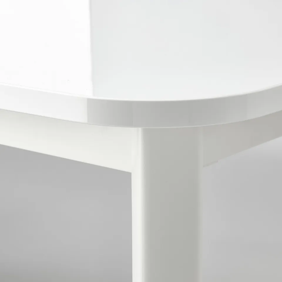 Close-up of STRANDTORP tables extendable crisp, white surface. Notice smooth edges and sturdy build.