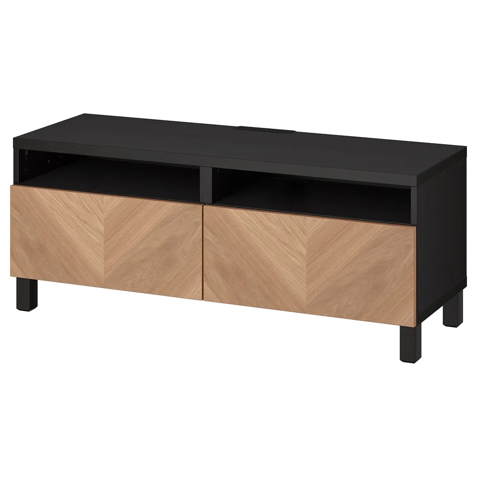 This image shows an ikea BESTÅ tv bench in black with wooden drawers. It open and closed storage with a sleek, modern design.