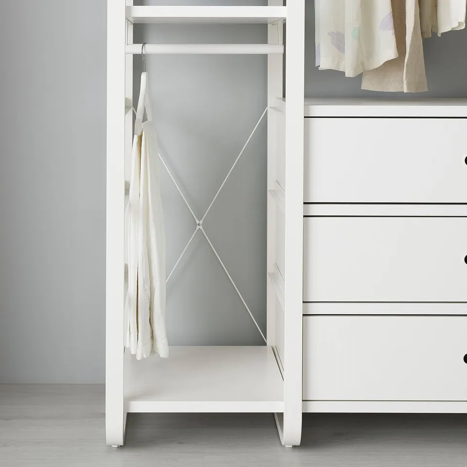 White ELVARLI storage unit with cross-brace for stability, hanging shirts.