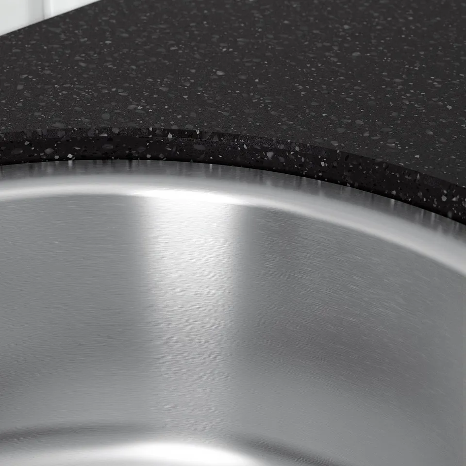 Stainless steel sink with granulated countertop, showcasing high-quality craftsmanship.