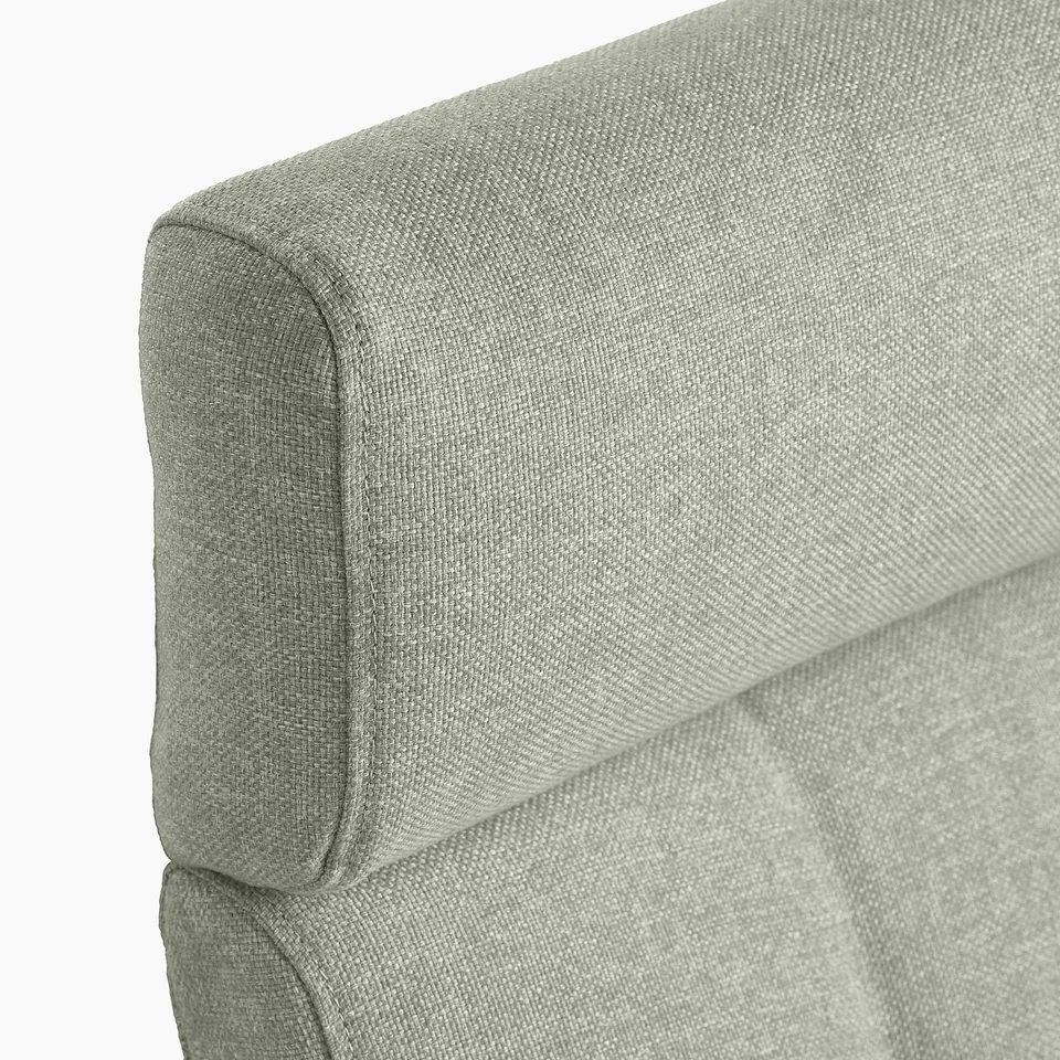 Soft, upholstered armchair corner with plush, textured fabric.