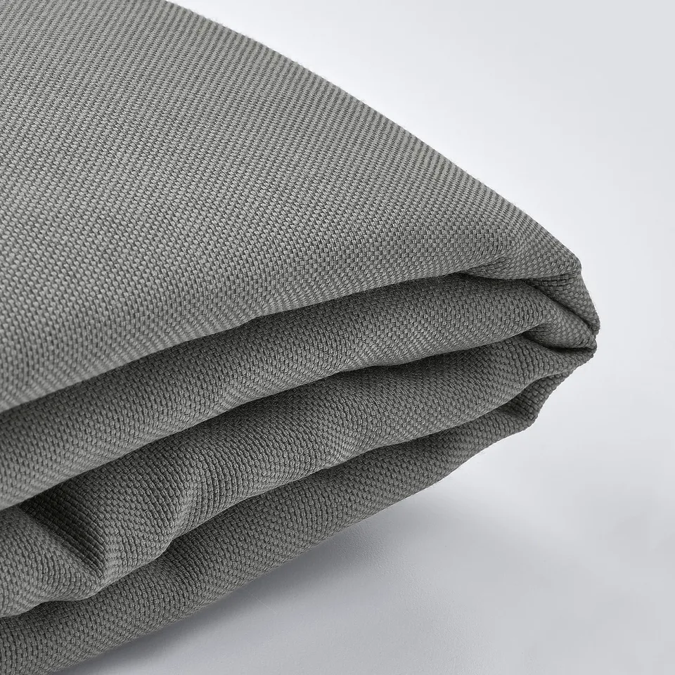 Close-up of durable, textured grey fabric with visible stitching, likely a cushion or mattress cover.