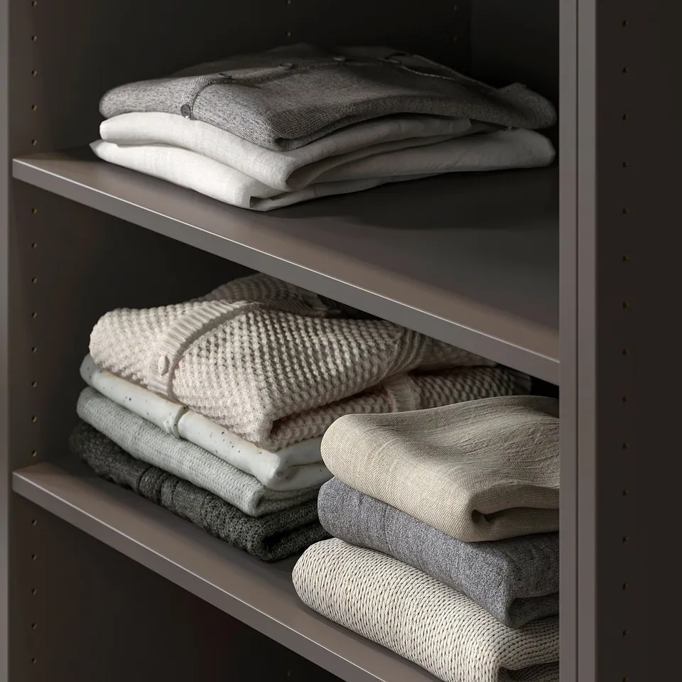 Folded towels on shelf in PAX wardrobe.