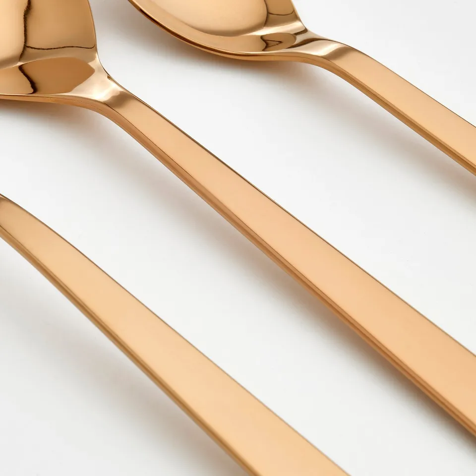 Golden cutlery set, polished stainless steel, elegant design.