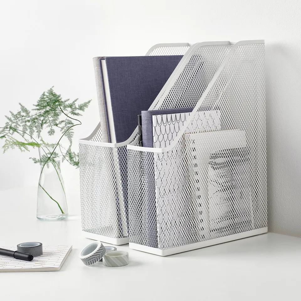 White DRÖNJÖNS mesh magazine file holds papers upright. Its lightweight design fits neatly on a desk, with a handle for easy access.