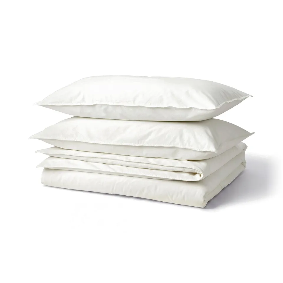 Stack of three white rectangular pillows, smooth fabric, neatly folded.