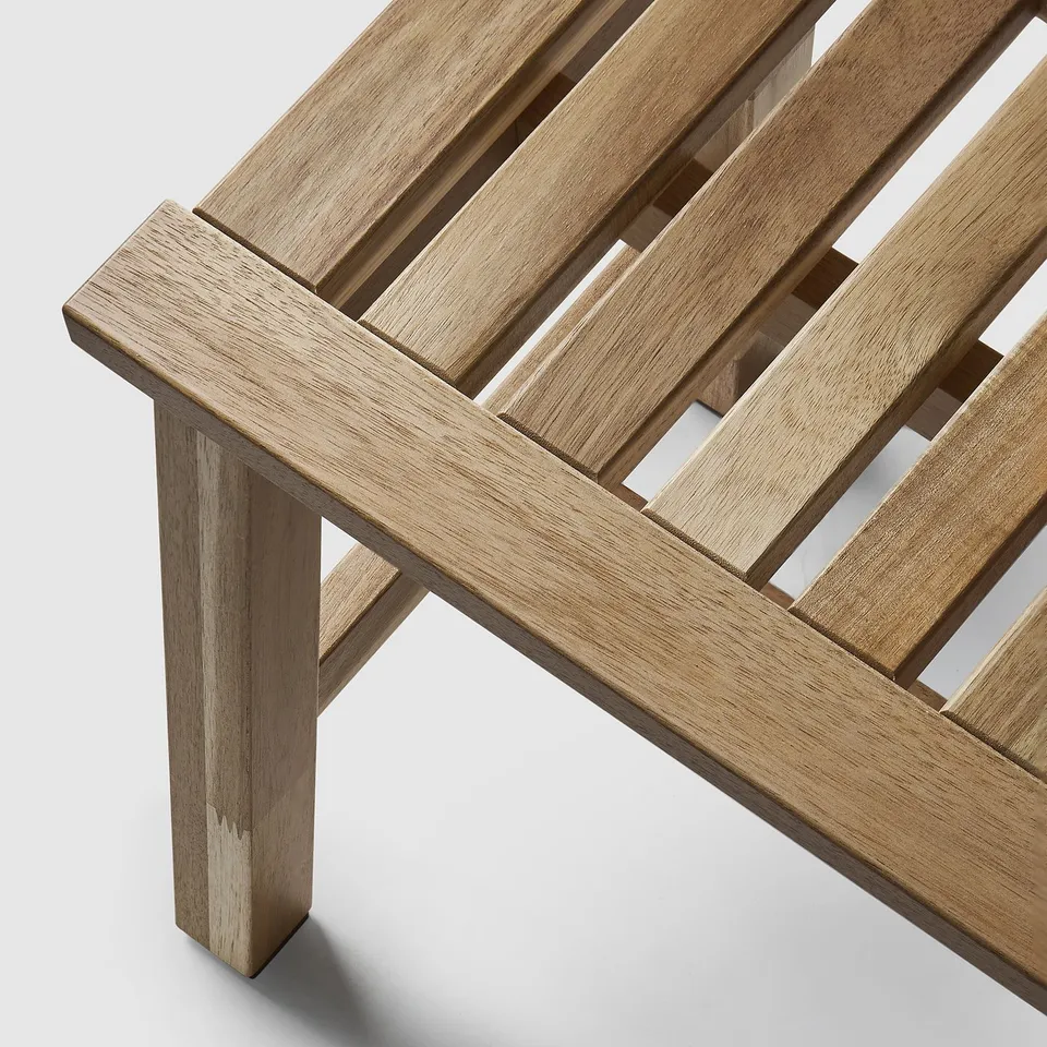 Versatile acacia wood bench from STOREDAMM series; offers seating and storage, showcasing natural wood grain and quality craftsmanship.