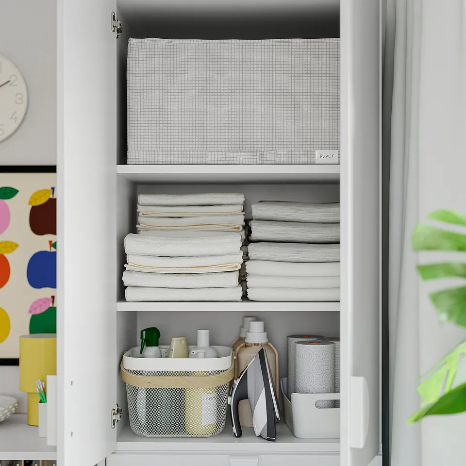 Open closet with neatly folded towels, toiletries in basket, and mesh bin.