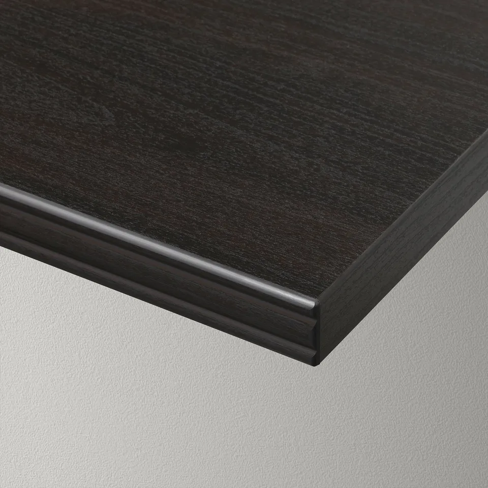 Close-up of a sleek, dark wooden tabletop with smooth, rounded edges against a plain background.