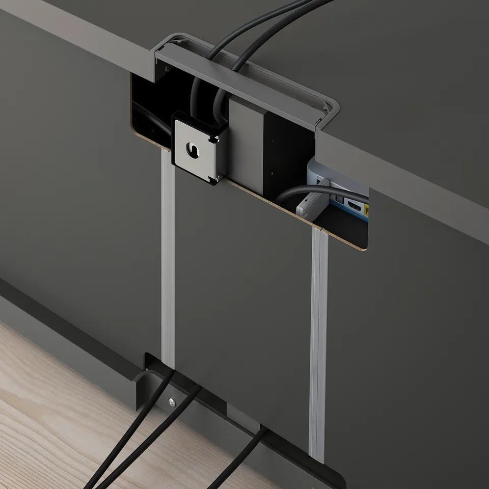 Cable management system: image shows back of tv bench with cable outlets and ties to keep cords tidy.