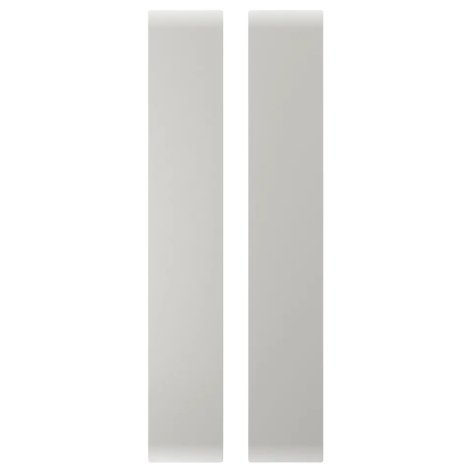 Two vertical white rectangular panels, part of a kids storage unit, made from fiberboard with rounded corners.