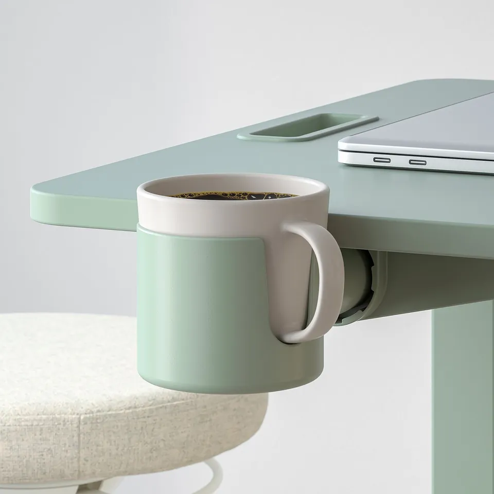 A green height-adjustable laptop table with a cup holder holding a mug of coffee.
