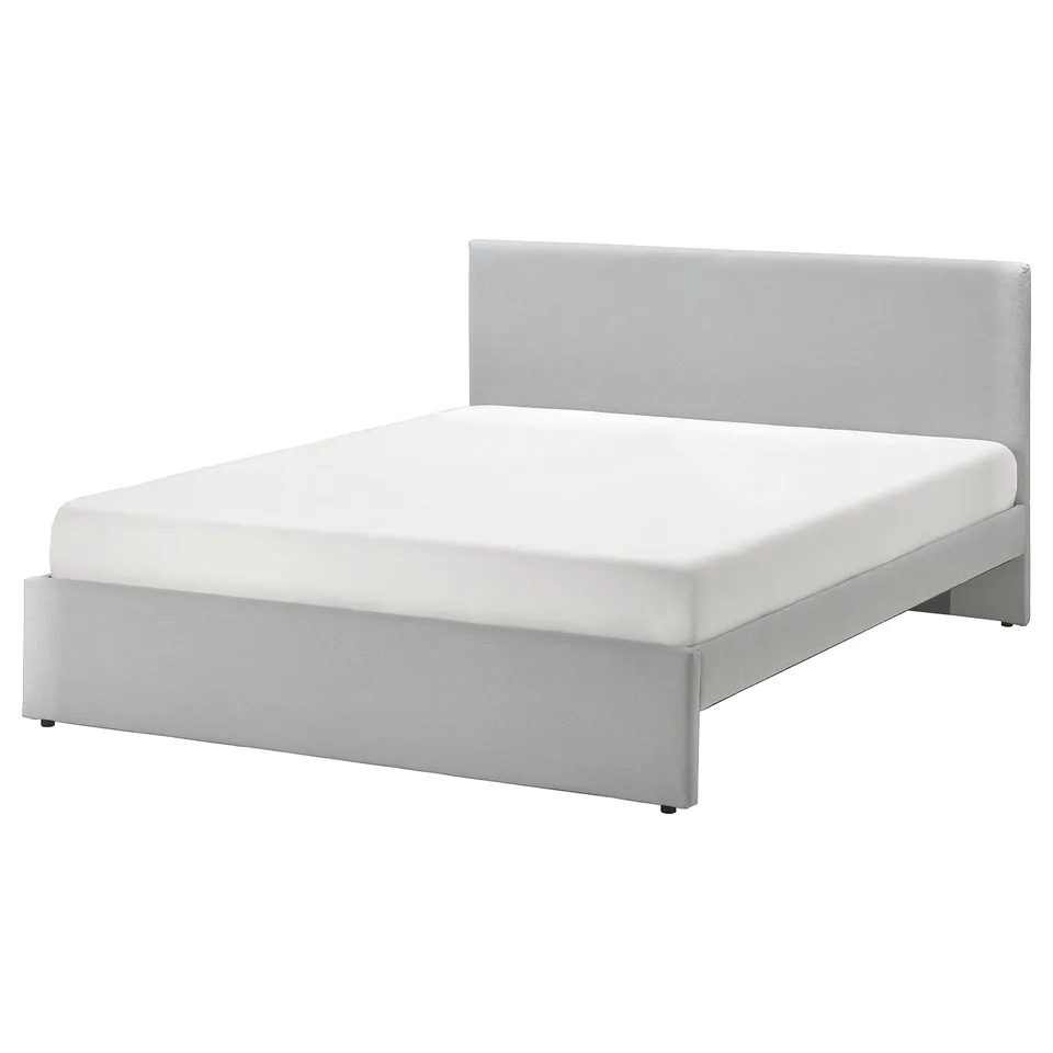 Modern grey upholstered bed with padded headboard, clean lines, and under-bed storage.