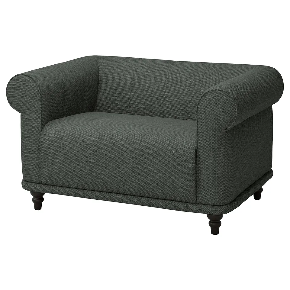 Green VISKAFORS armchair; round design, soft fabric; wooden legs.