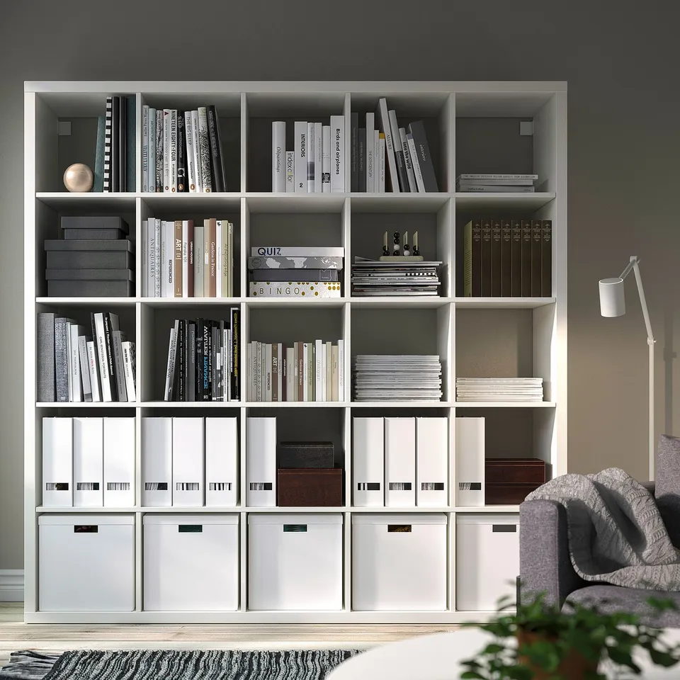 KALLAX white shelving unit with books & storage, dividing room, & cosy reading nook.