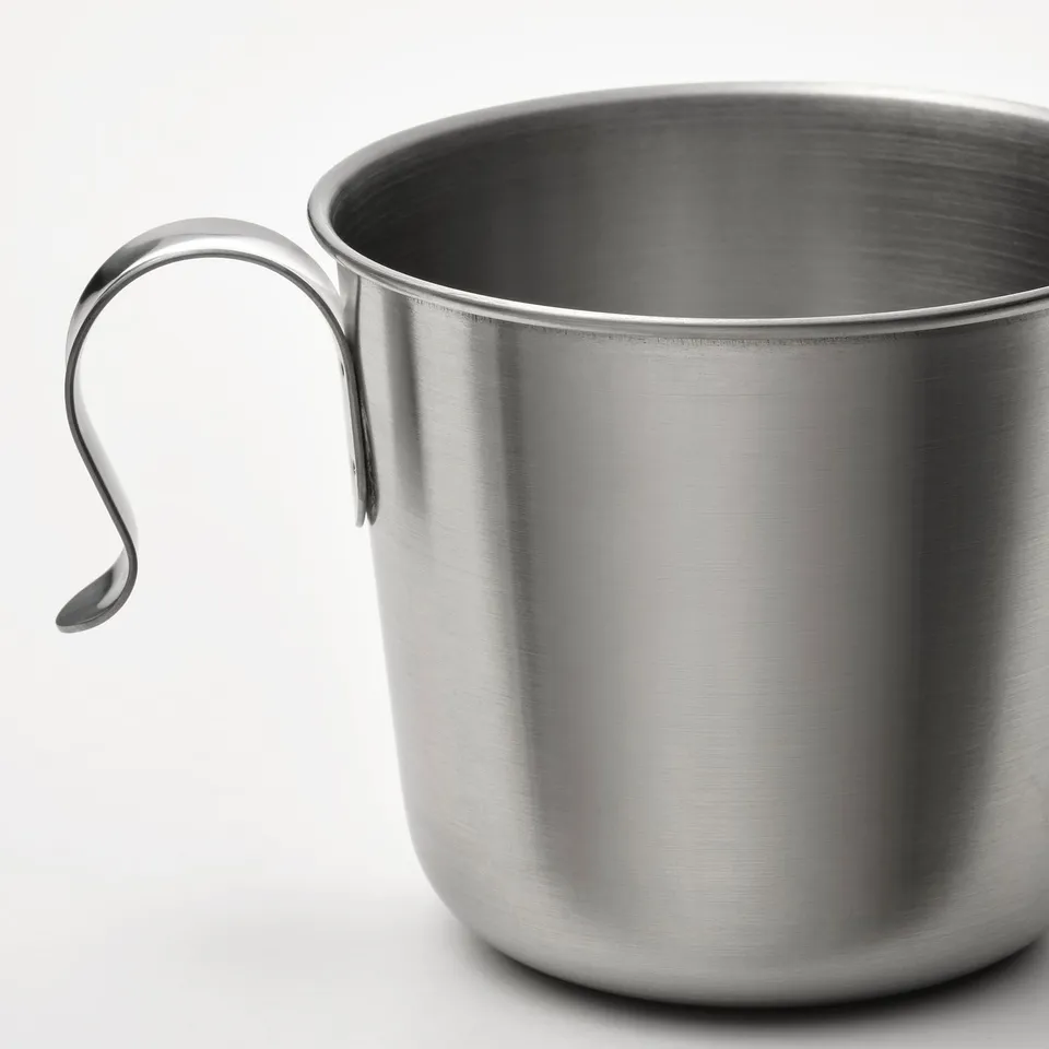 Stainless steel camping mug with sturdy handle, durable, lightweight, perfect for outdoor use.