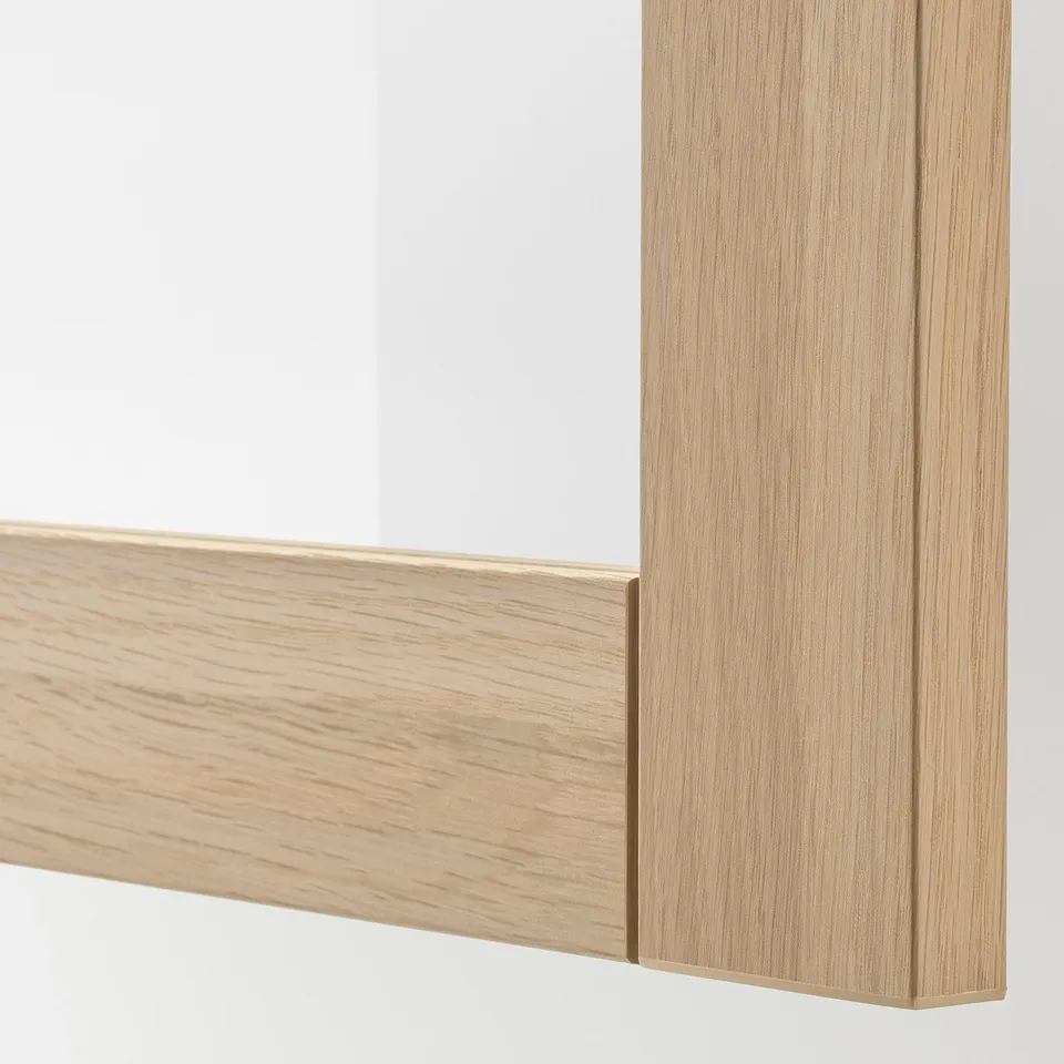 A close-up view of a wooden-framed glass door, showcasing its sturdy, light-colored wooden edging and clear glass panel.