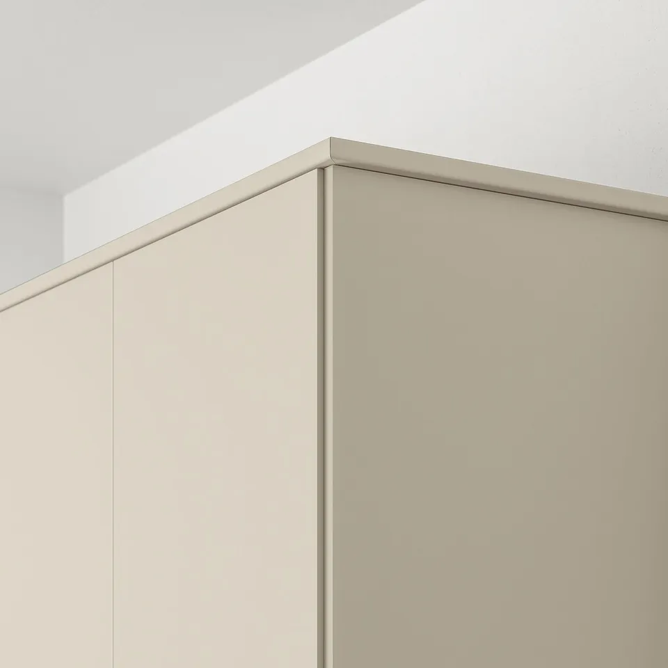 Close-up of HAVSTORP kitchen trim, beige, hiding under cabinet lighting and cords.