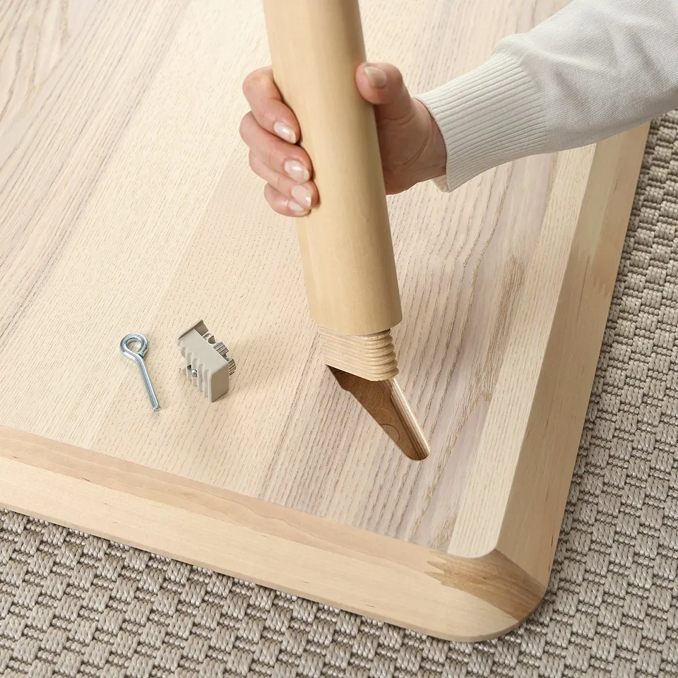 Assembling LISABO furniture with rubber mallet.
