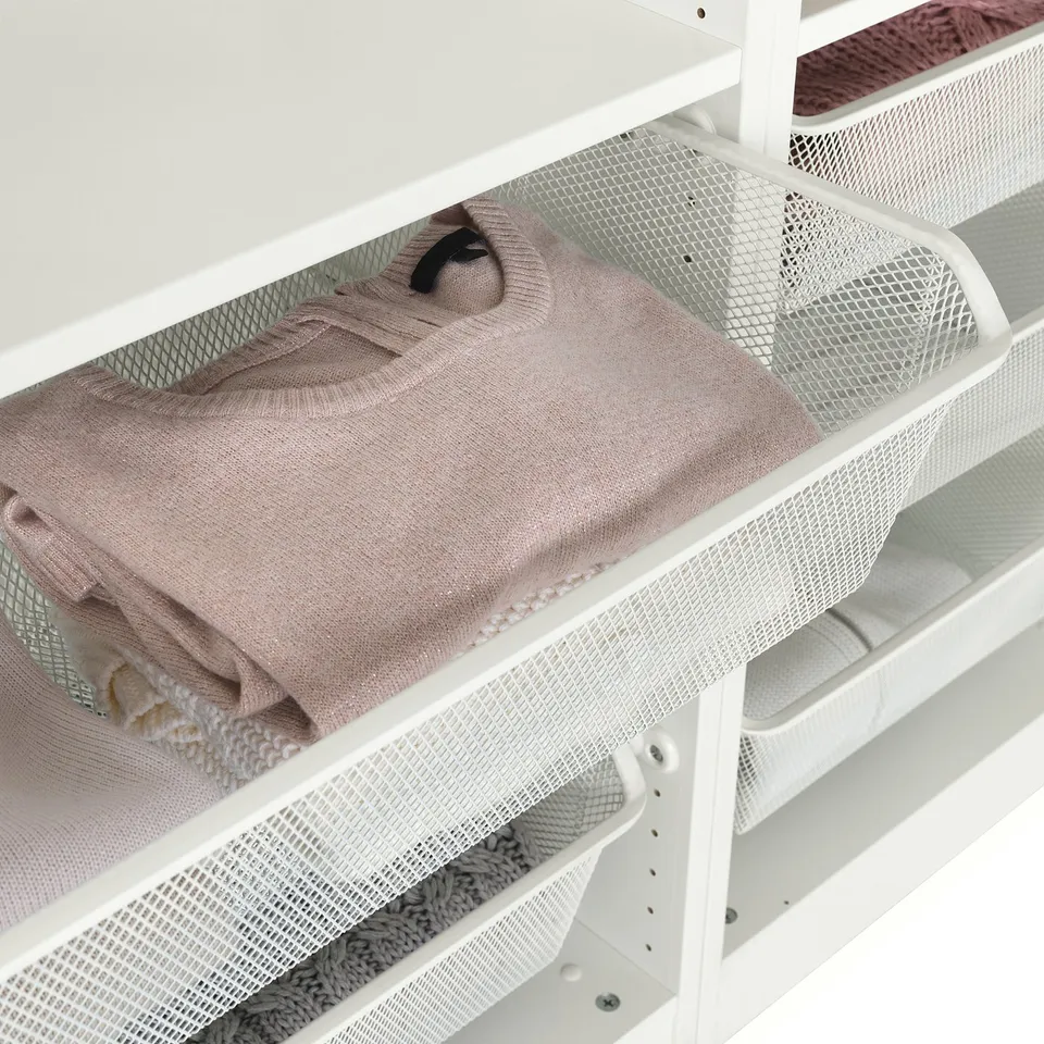Mesh basket holding folded beige sweater, allowing air circulation and easy visibility.