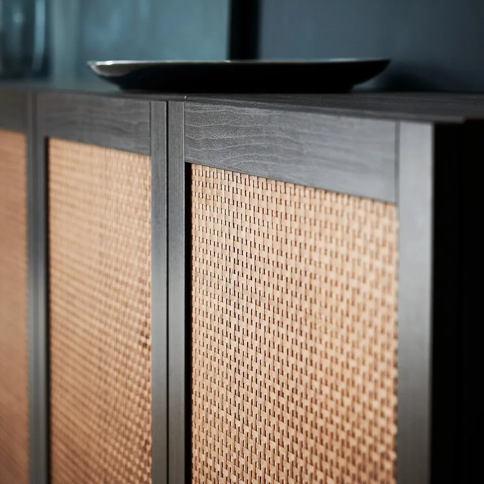 A brown woven front cabinet with a dark frame.