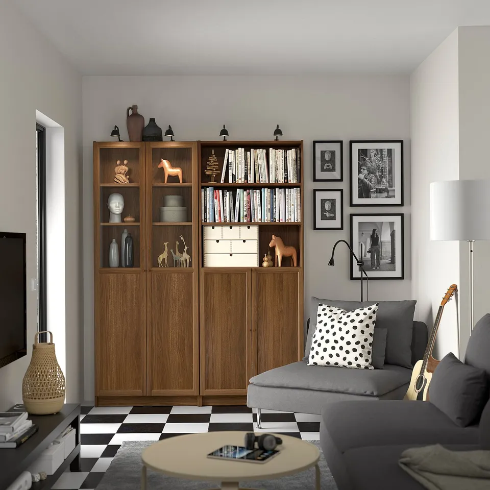 Cosy living room with BILLY bookcase, sofa, and camera on coffee table.