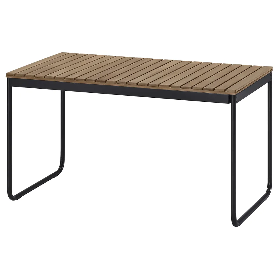 Shows VÄSMAN table: acacia wood top, black steel frame, outdoor design.