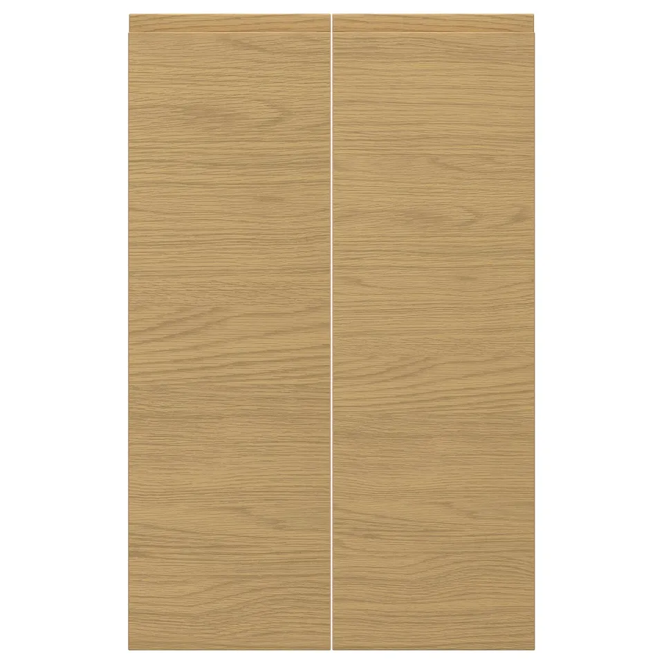 VOXTORP oak finish door panels, sleek with integrated handles, warm modern style.
