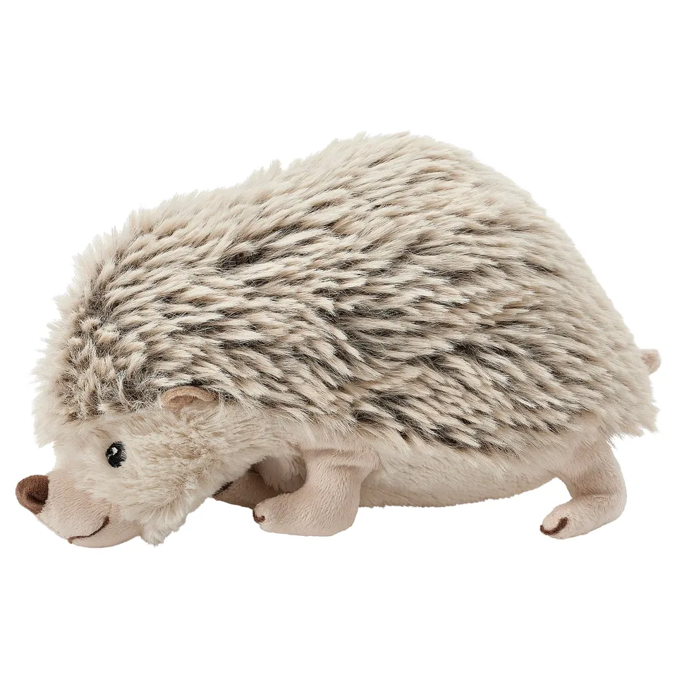 Cuddly toy hedgehog, tan, black spots, round body, soft, smiley face.