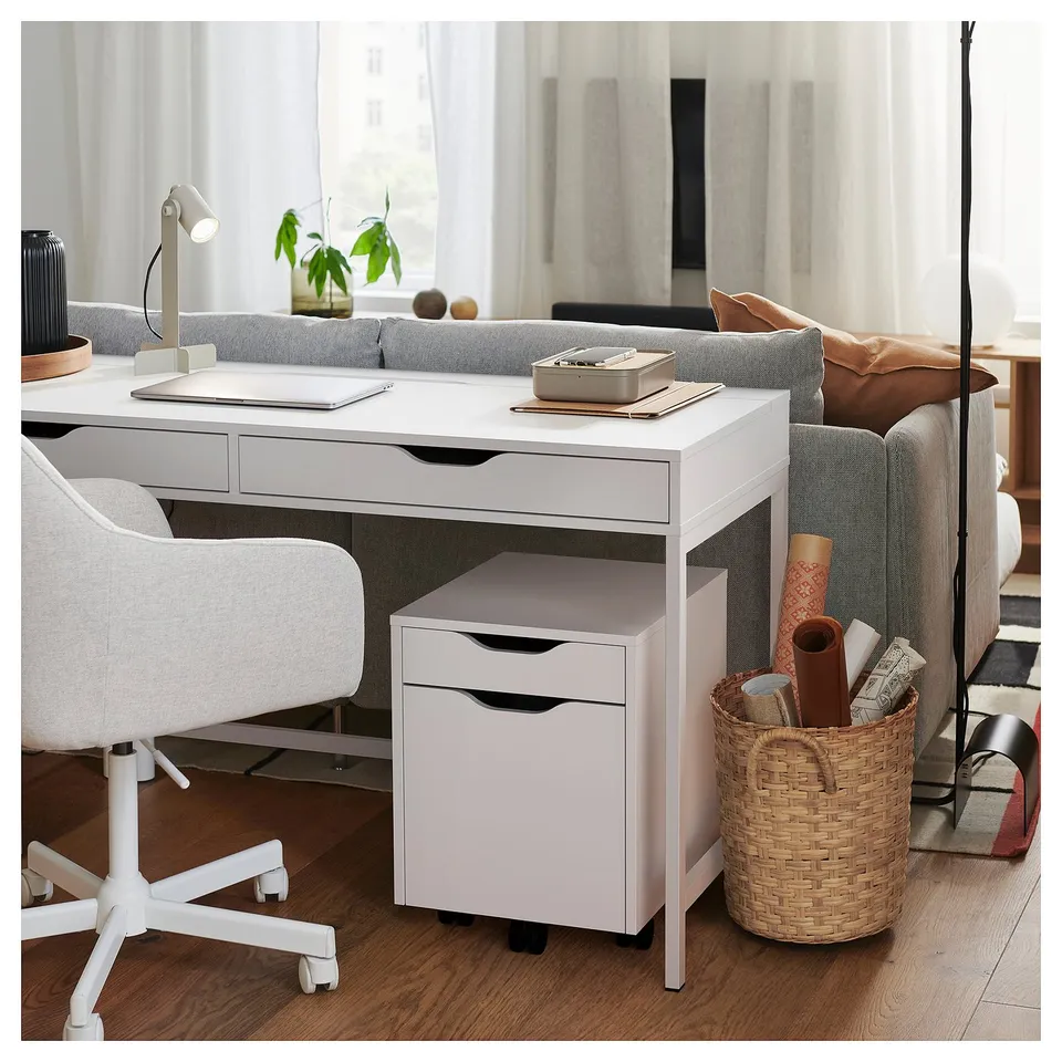 Modern home office with ALEX desk and chair, storage, wooden floor, cosy seating.