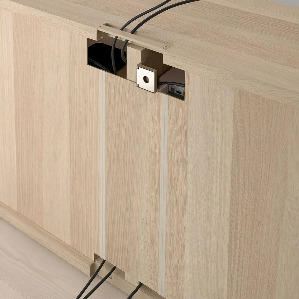 Wooden tv bench with cable management outlets, adjustable feet, and a cutout for wires.