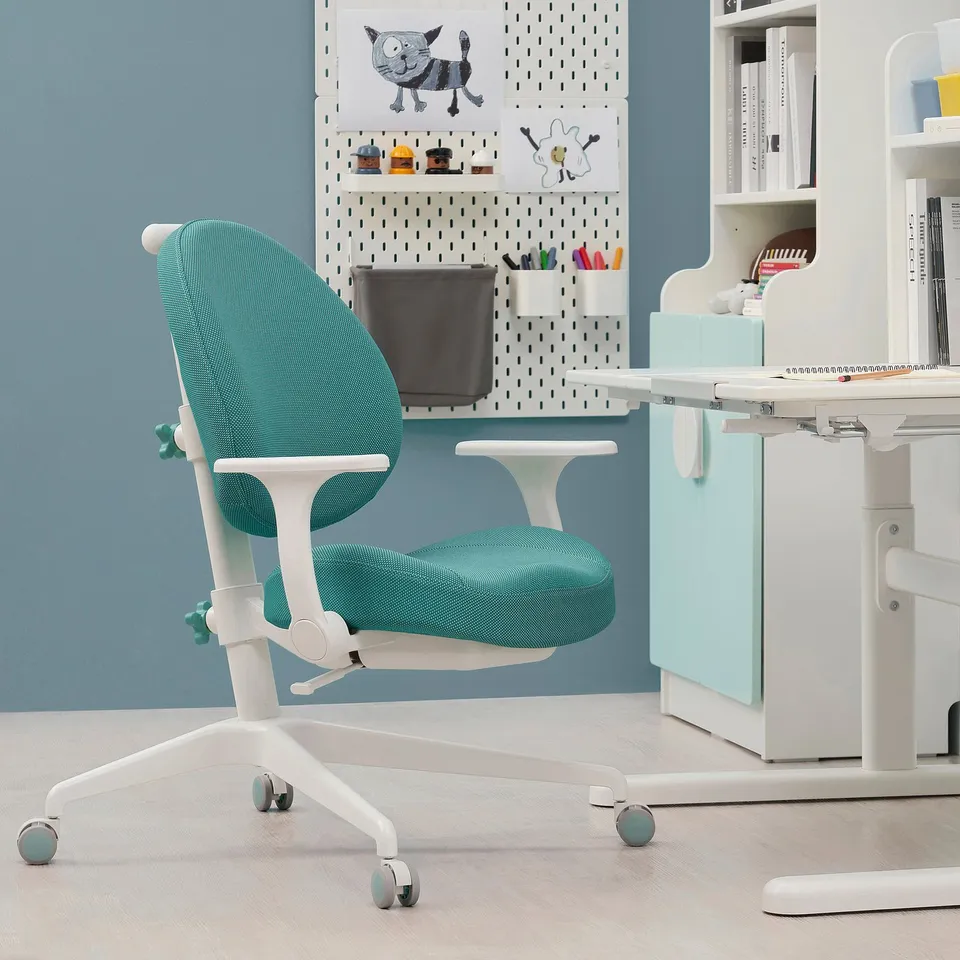 Bright blue adjustable GUNRIK kids chair, padded, near white study desk with colourful supplies.