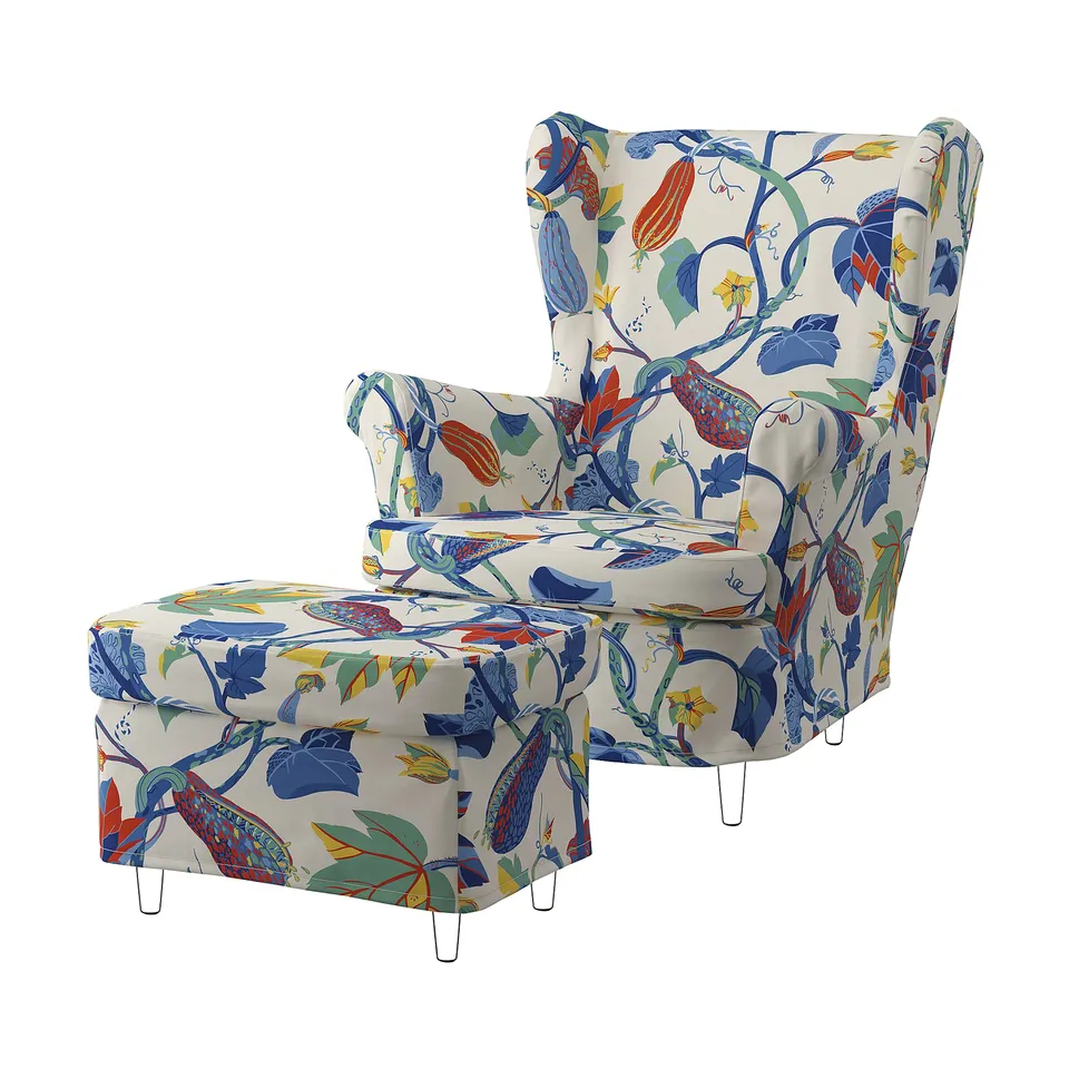 Bright, patterned armchair and footstool with floral and leaf designs in blue, orange, and yellow on white fabric, recycled polyester and cotton.
