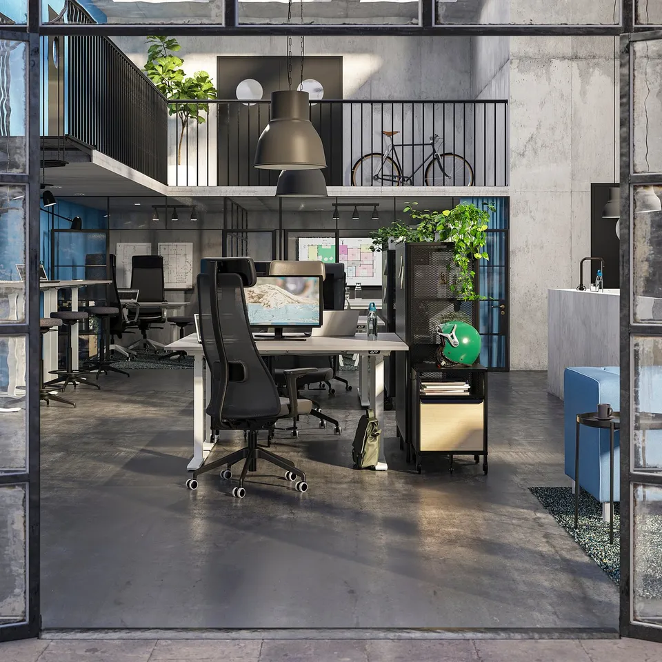 Modern office with ergonomic chairs, high ceilings, large windows, and industrial design.