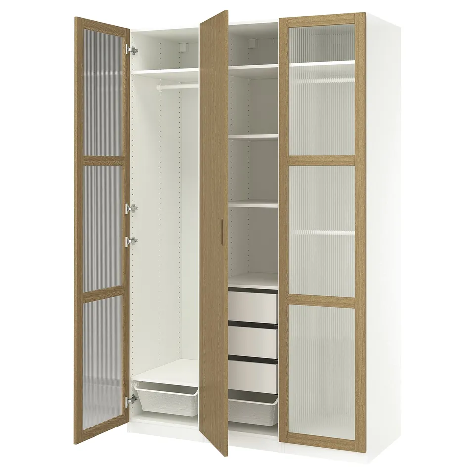 White PAX wardrobe with oak trim, glass doors open, showing shelves and drawers.