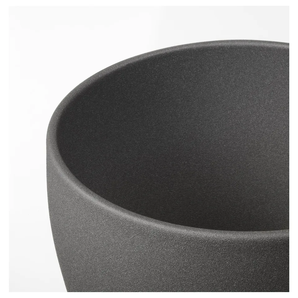 Dark cylindrical planter with smooth, glossy finish. Shown in close-up, highlighting durable texture and sleek design.