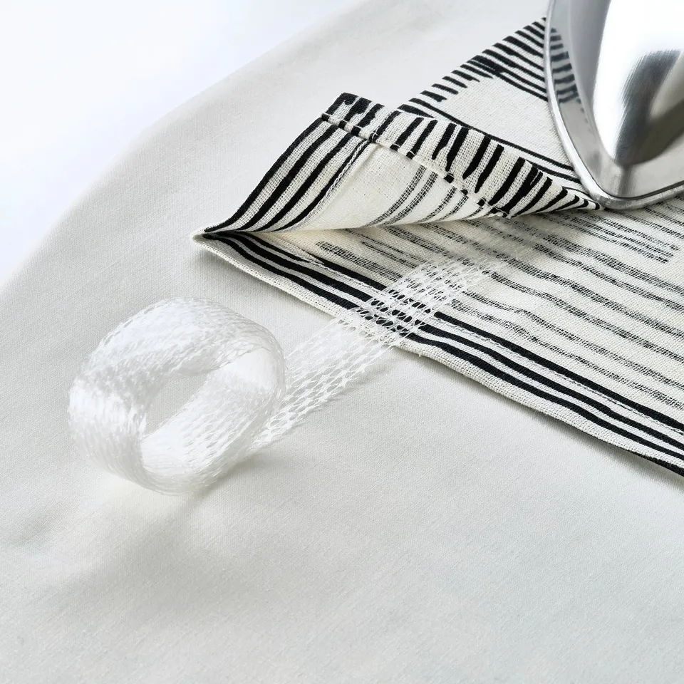 A fabric with heading tape, ready for hooks or rail, showing iron and thread nearby.