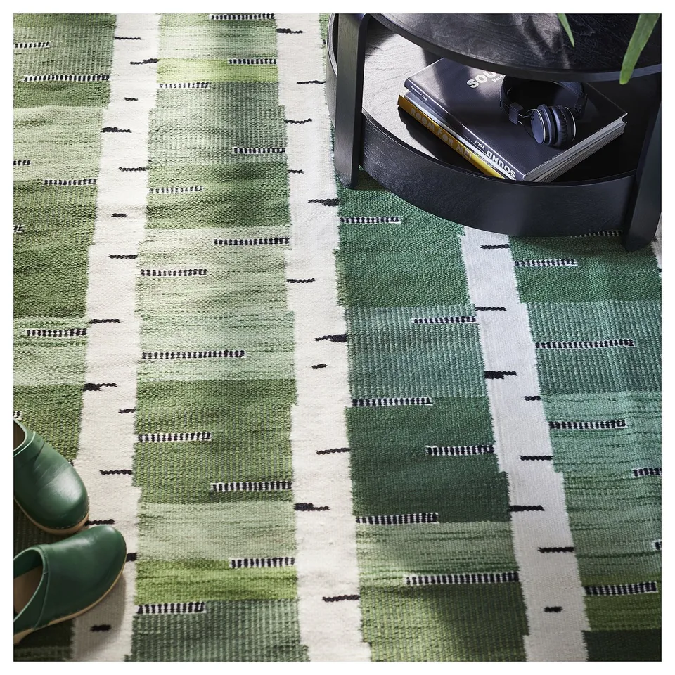 Handwoven green wool rug with birch tree pattern on reversible sides. Stunning scandinavian design, perfect for living or dining areas.