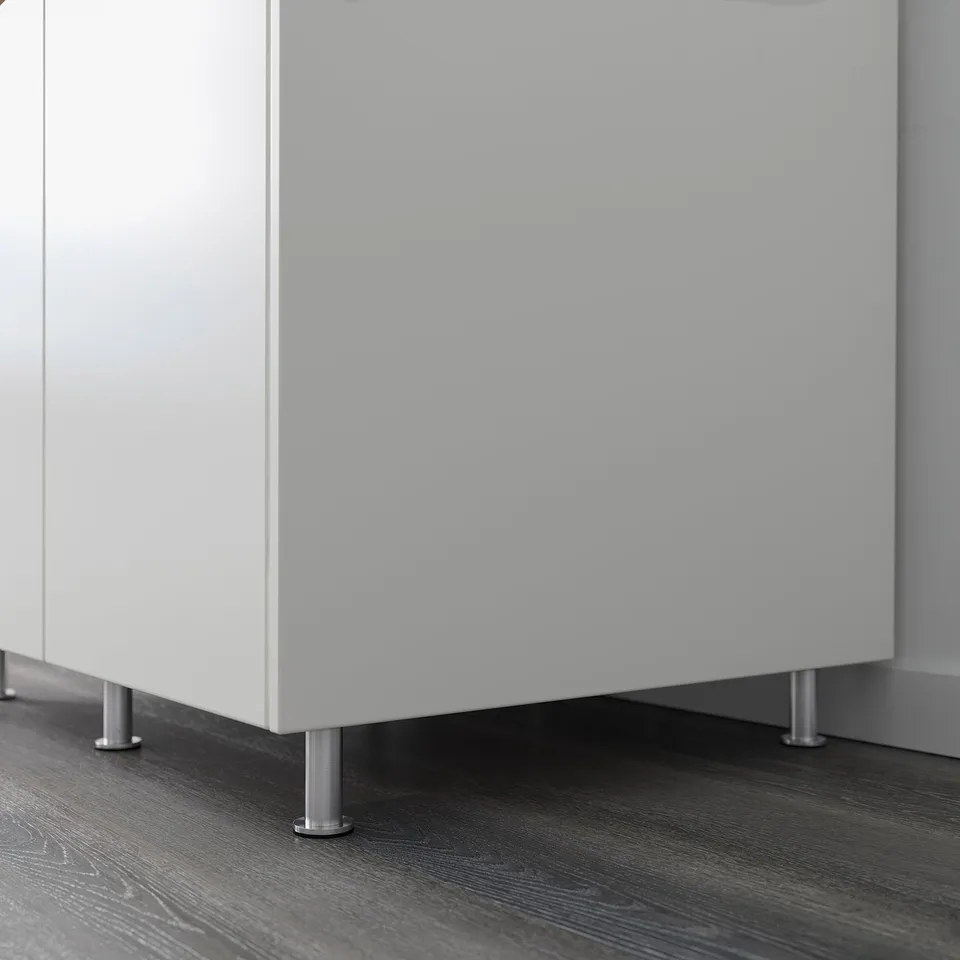 White cabinet with metallic legs ensuring stability on uneven floors.