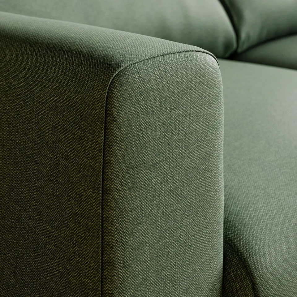 Green fabric sofa close-up, revealing smooth texture and stitching detail.