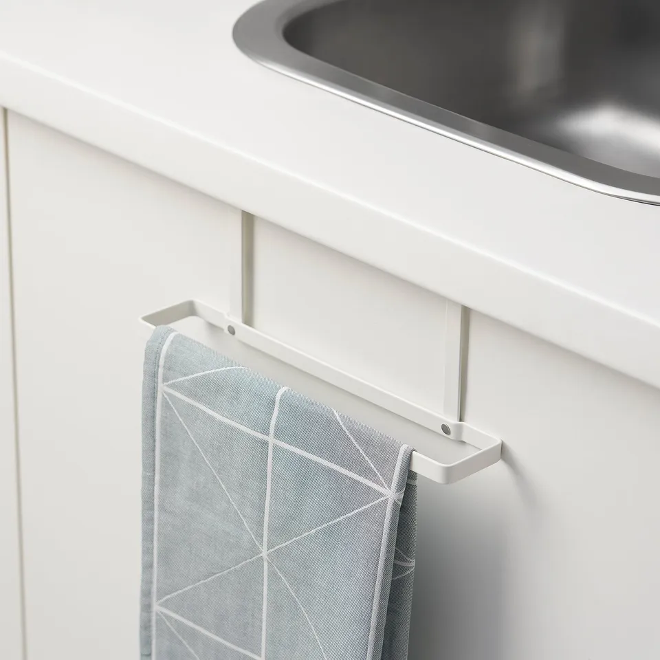 White over-door towel rack holding blue geometric-patterned cloth in modern kitchen.
