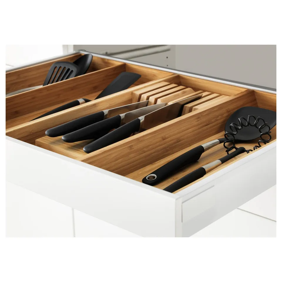 Organised kitchen drawer with bamboo knife block and utensils.