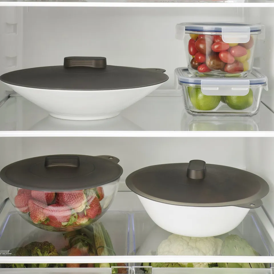 Fridge shelf with 3 covered bowls. Two silicone lids vacuum seal fresh produce.