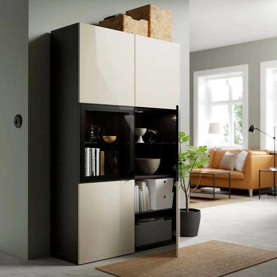 Modern living room with BESTÅ storage, glass doors, baskets, plant.