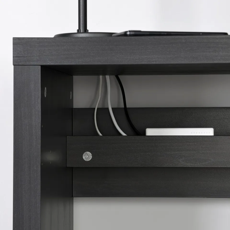 Black KALLAX shelf with cables and a box, showing cable management.