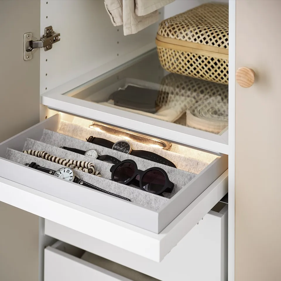 White KOMPLEMENT tray organises accessories with felt-lined compartments, pulled out for easy access.