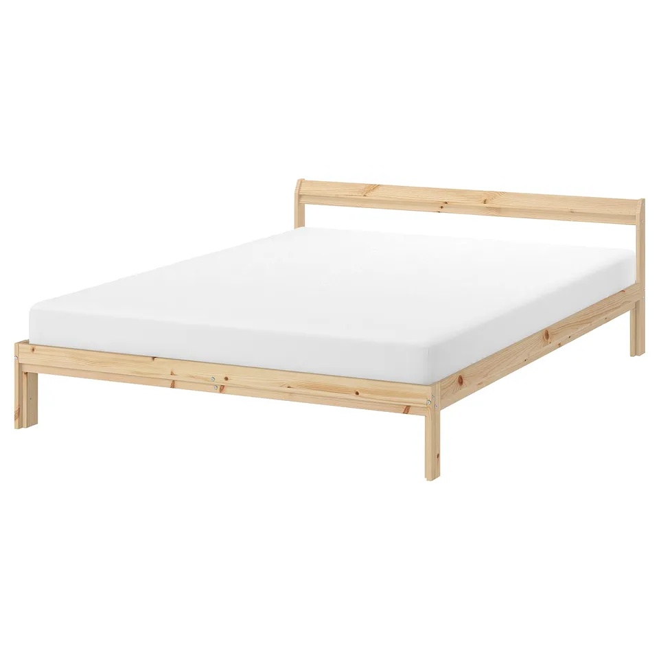 A NEIDEN wooden bed frame in natural colour with a white mattress. It a simple, rectangular design made from solid pine.