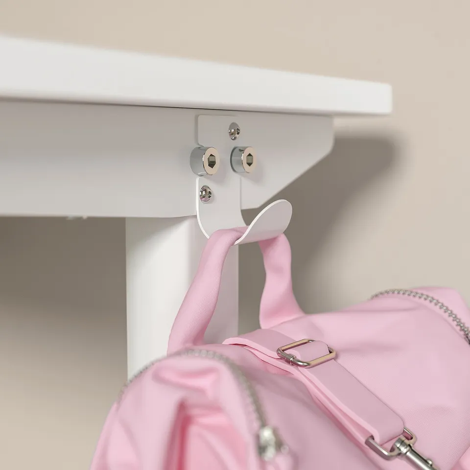 A white RELATERA desk with a pink bag hanging from it. The desk has adjustable height and built-in cable organisers.